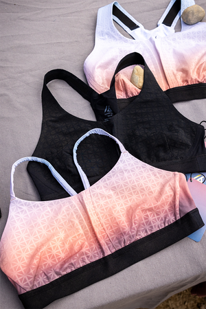 Low, Medium, and High Impact sports bras laying on a table