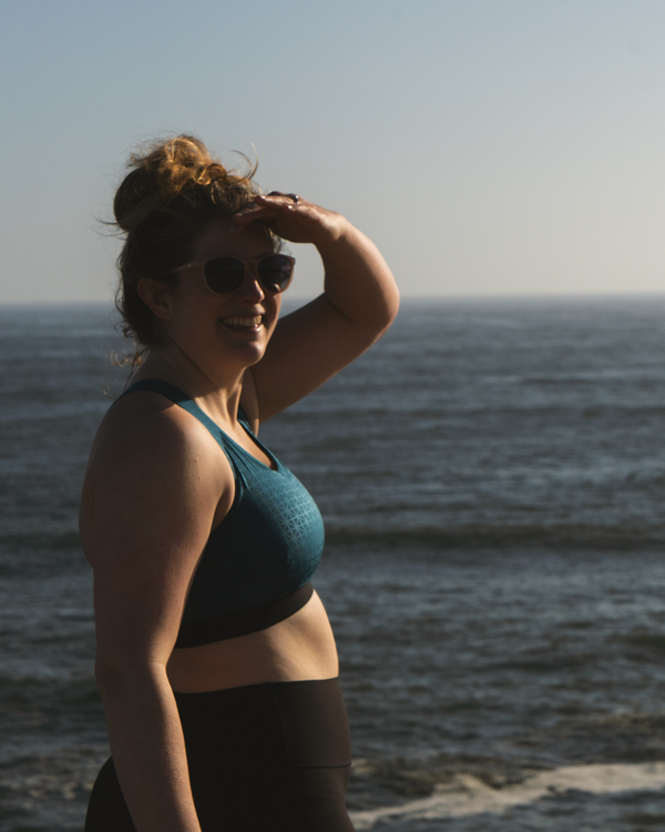 Woman in sports bra at the ocean